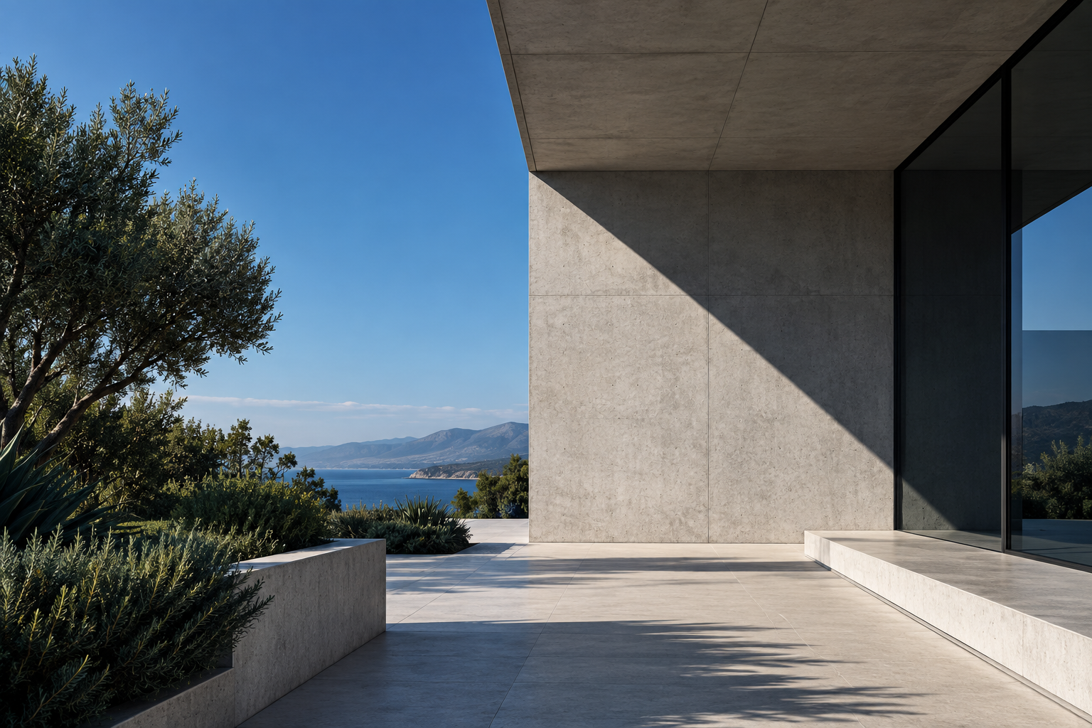 A modern concrete building beside the sea